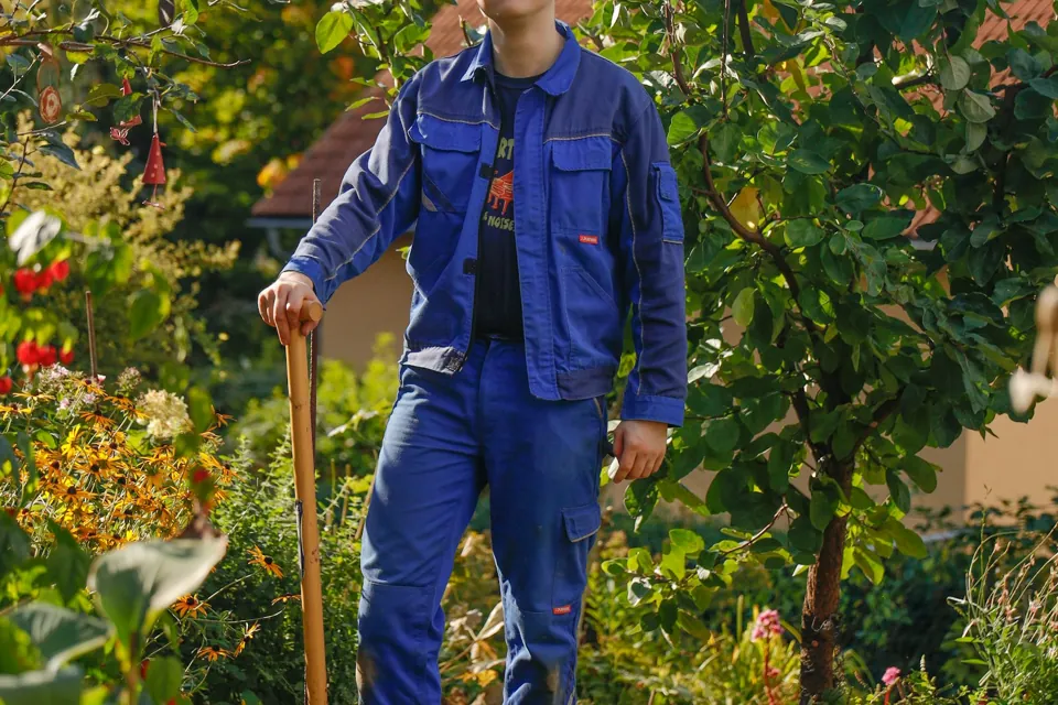 Person preparing for residential garden work; illustrative stock photography.